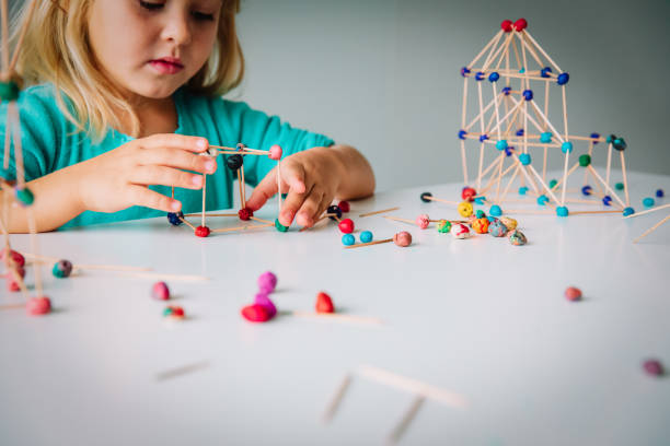 istock little girl making geometric shapes, engineering and STEM 1064557302