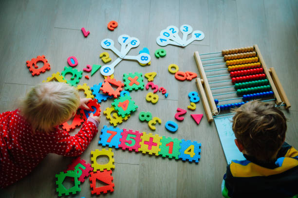 istock kids- boy and girl- learning numbers, abacus calculation 1064558856