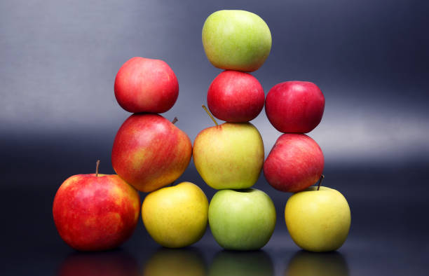 istock Wall of fresh different apples on dark background 1064559070