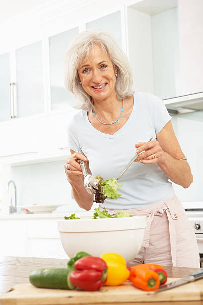 istock Senior Woman Preparing Salad In Kitchen 106456037