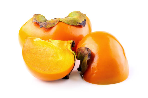 istock fresh persimmons and persimmon slice with leaf isolated on white background 1064560542