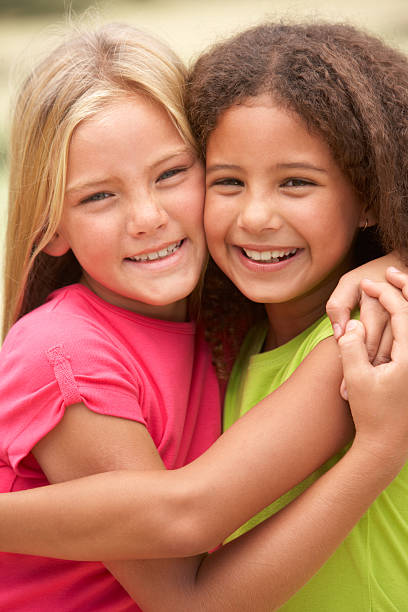 istock Two Girls In Park Giving Each Other Hug 106456100