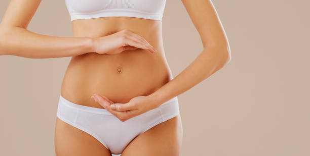istock A woman holds her hands at the belly. 1064562102