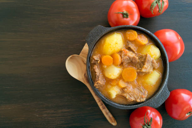 istock thick Hungarian soup, the goulash. on dark background. 1064565414