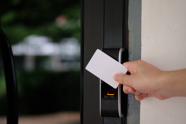 Biometric fingerprint scanner with keycard. Electronic key access system with hand inserting key card to unlock door. control stock pictures, royalty-free photos & images