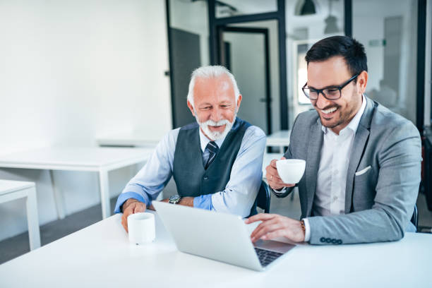 istock Successful senior and junior businessman on a meeting. 1064568908