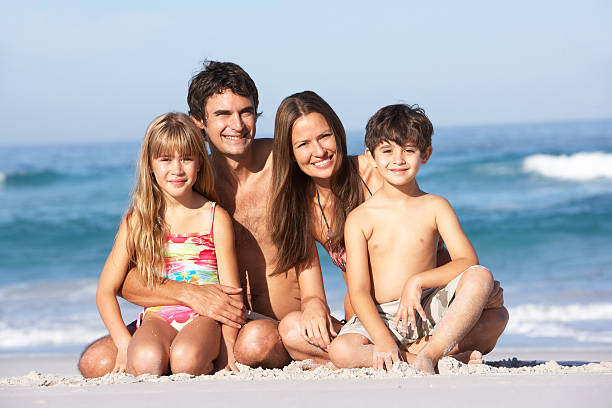istock Young Family Relaxing On Beach Holiday 106456916