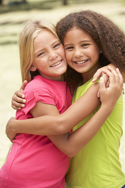 istock Two Girls In Park Giving Each Other Hug 106456974