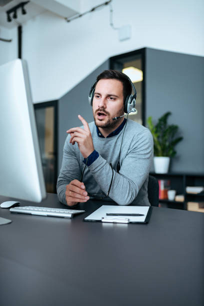 istock Young support center employee arguing with clients. 1064569998