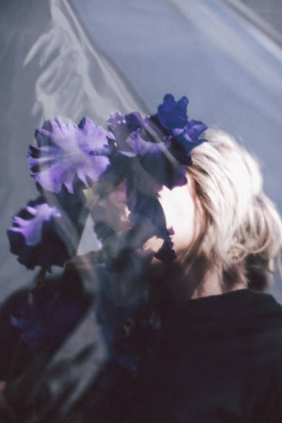 istock Young woman posing with flowers 1064570416