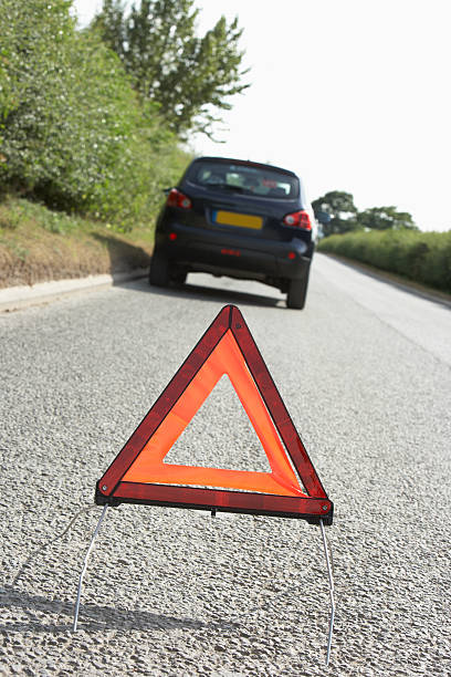 istock Car Broken Down On Country Road With Hazard Warning Sign 106457042