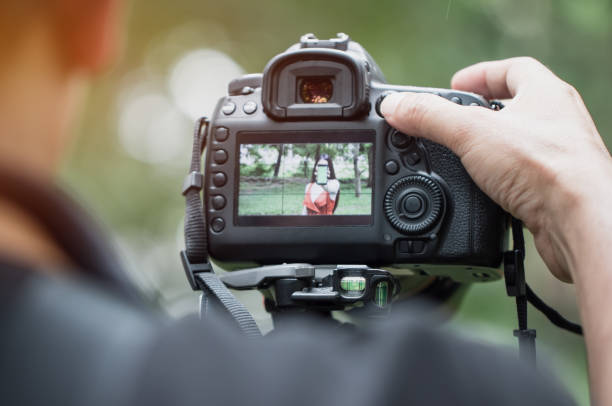 istock asian beauty vlogger review smartphone tutorial vlog viralclip on live streaming and behind cameraman Video or professional digital mirrorless on tripod for camera recording at outdoor 1064570874