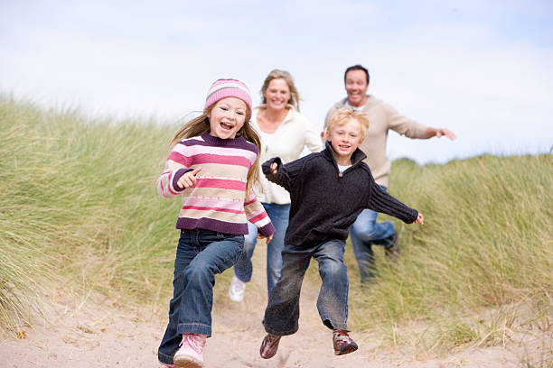 istock Family running on beach smiling 106457104