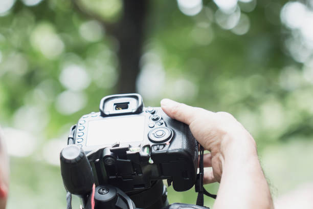 istock cameraman set video camcorder interviews or professional digital mirrorless on tripod for camera recording, light bokeh at nature 1064571056