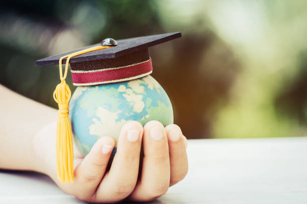 istock Education world or Graduated study abroad international ideas. Graduation hat on top Earth globe model map background. Congratulations to graduates university lead to success in world. Back to School 1064571208
