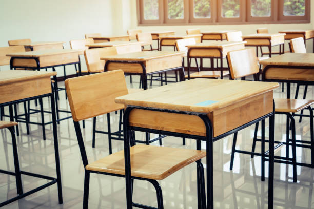istock Back to school concept. School empty classroom, Lecture room with desks and chairs iron wood for studying lessons in highschool thailand without young student, interior of secondary education 1064571280