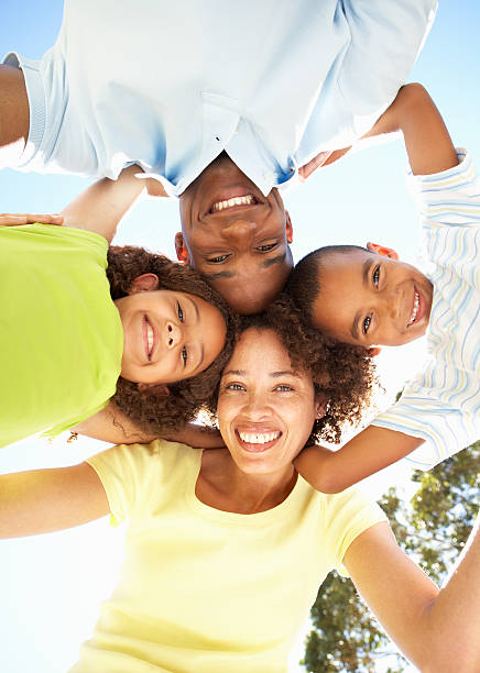 istock Smiling family looking down into camera outdoors 106457211