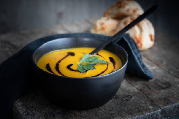 a bowl with creamy pumkin soup stock photo
