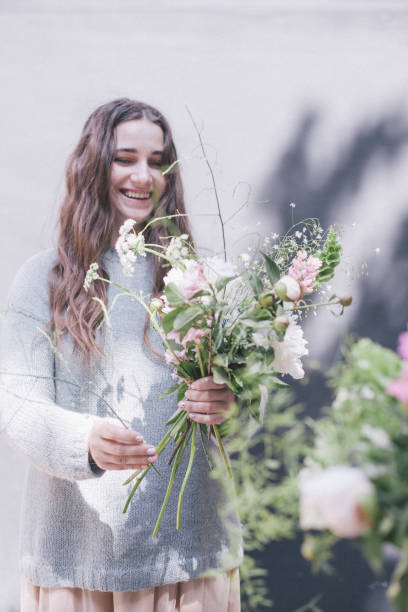 istock Young woman posing with flowers 1064574098