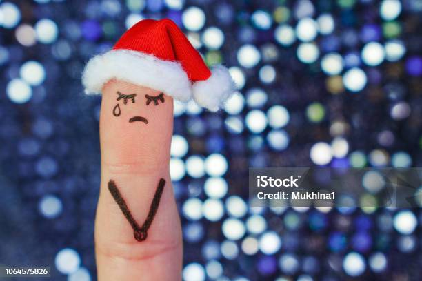 Finger Art Of Lonely Woman Is Crying Concept People Celebrate Christmas In New Year Hat Toned Image Stock Photo - Download Image Now