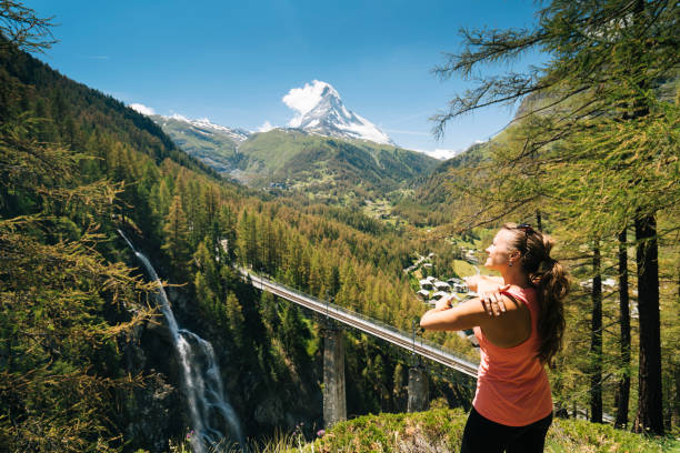 istock Woman applying sunscreen, Matterhorn distant 1064575852