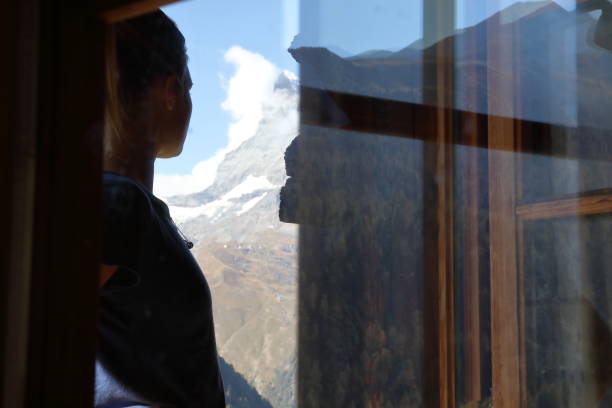 istock View through glass window to woman looking out 1064576652