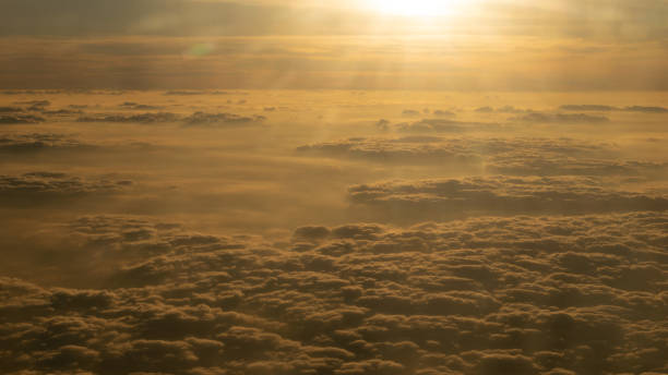 istock Image of Sunrise above the clouds from airplane window, India 1064577590
