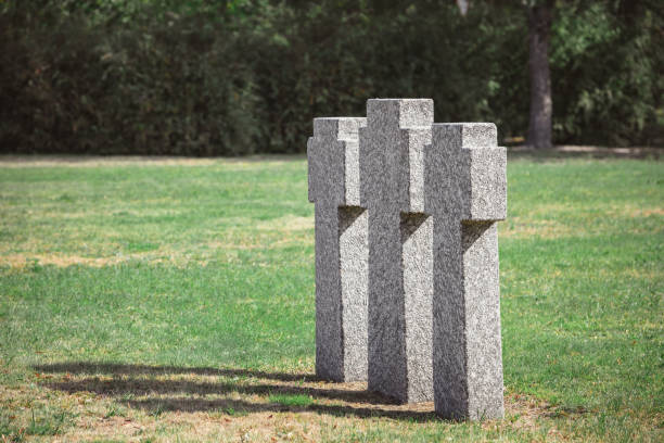 istock selective focus of old gravestones on grass at cemetery 1064578750