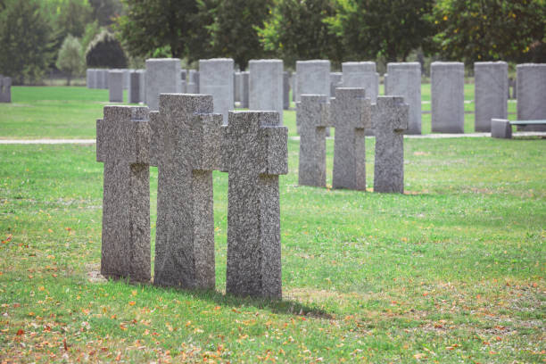 istock rows of identical old gravestones on grass at graveyard 1064578766