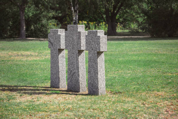 istock scenic view of identical old gravestones on grass at graveyard 1064578768