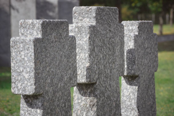 istock selective focus of memorial stone crosses placed in row at graveyard 1064579038