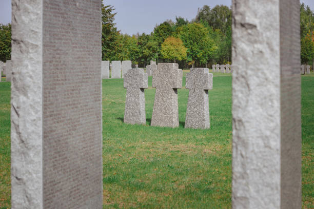 istock selective focus of identical memorial stone crosses placed in row at graveyard 1064579172