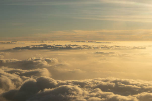 Image of Sunrise above the clouds from airplane window, India