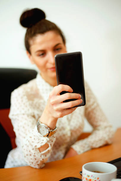 istock Attractive businesswoman using mobile phone in office 1064582860