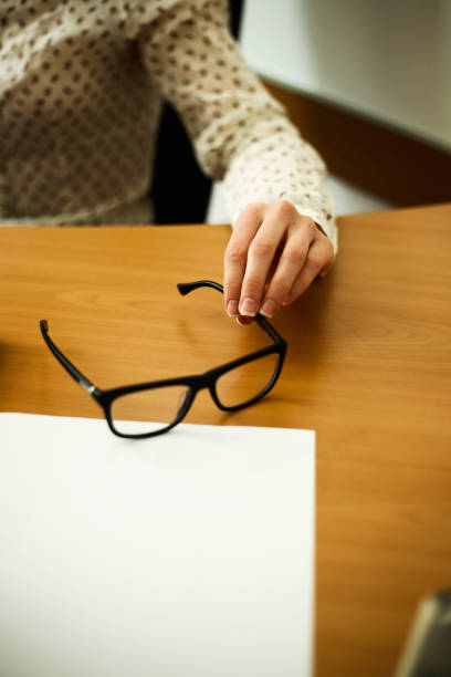 istock Close up eyeglasses on office desk 1064585300