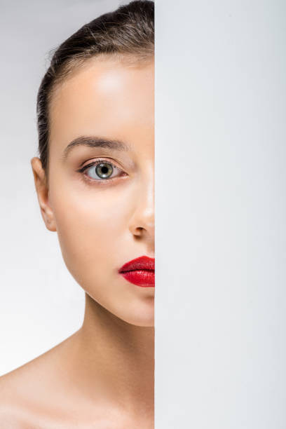 istock young woman hiding face behind white empty board 1064586186