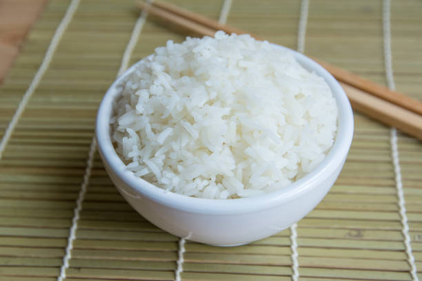 istock Jasmine rice in white cup On a bamboo mat 1064588832