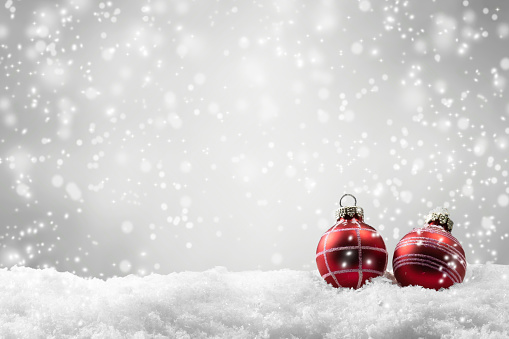 red christmas balls in snow cover