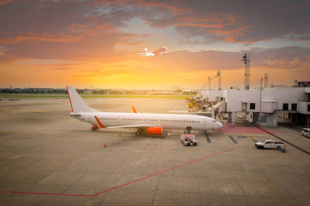 istock airplane ready for boarding in a airport hub at sunset 1064591176