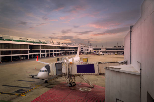istock airplane ready for boarding in a airport hub at sunset 1064591180