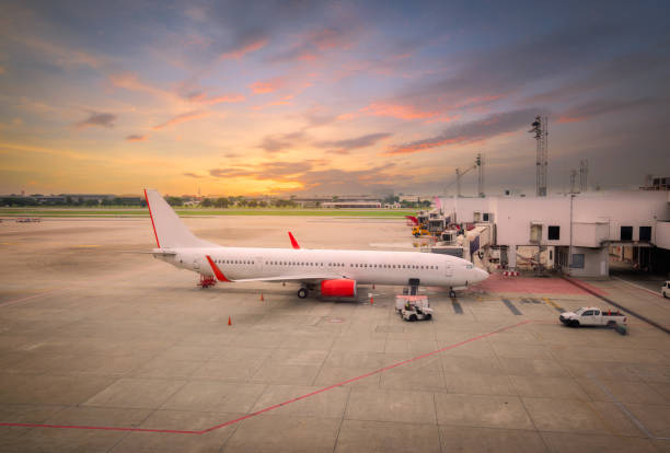 istock airplane ready for boarding in a airport hub at sunset 1064591238