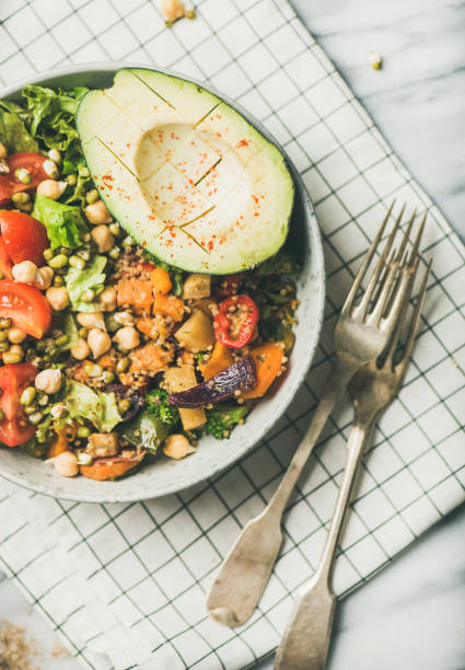 istock Vegan dinner with avocado, grains, beans and vegetables, top view 1064591970