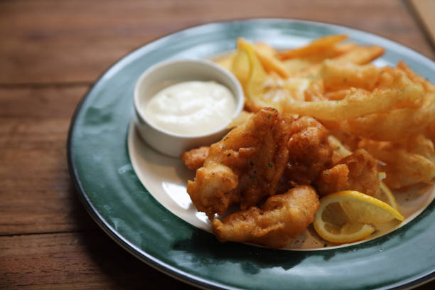 istock Fish and chips fried fish and potatoes on wood background vintage style 1064598592