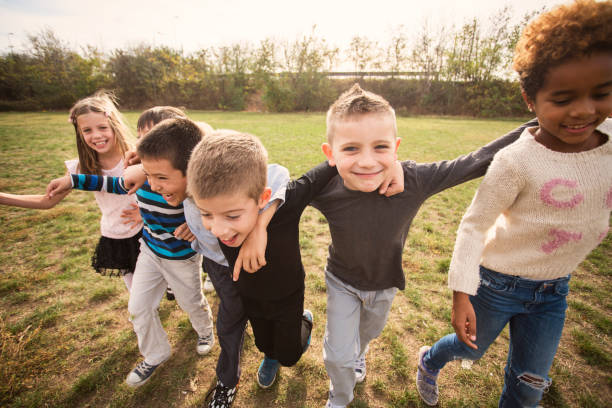 istock Happy kids running on meadow 1064599442