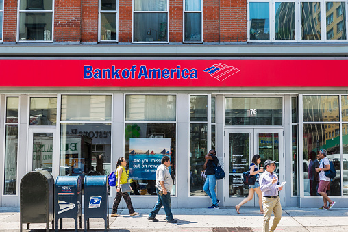 New York City, USA - July 26, 2018: Facade of a bank branch of Bank of America on the street with people around in New York City, USA
