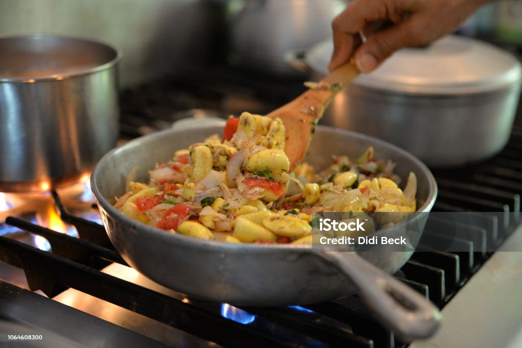 Ackee and Saltfish Jamaican national dish, ackee and saltfish, cooked in a traditional dutch pan over a flame. Food Stock Photo