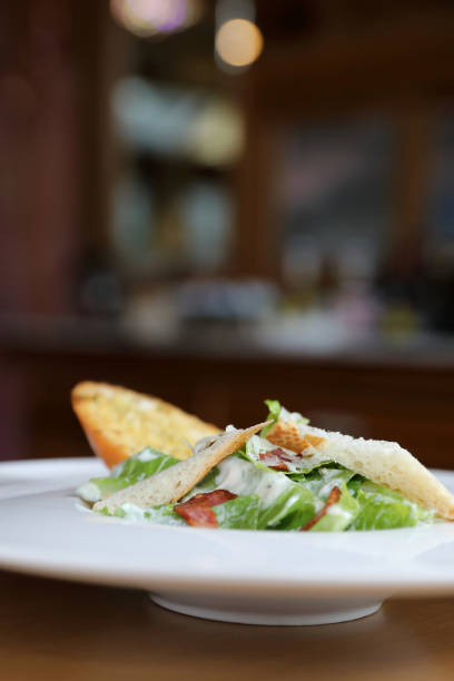 istock fresh salad with bacon and bread on wooden background 1064608430