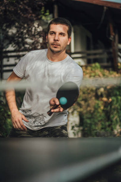 istock Table tennis player is making a service, recreation activity 1064619030