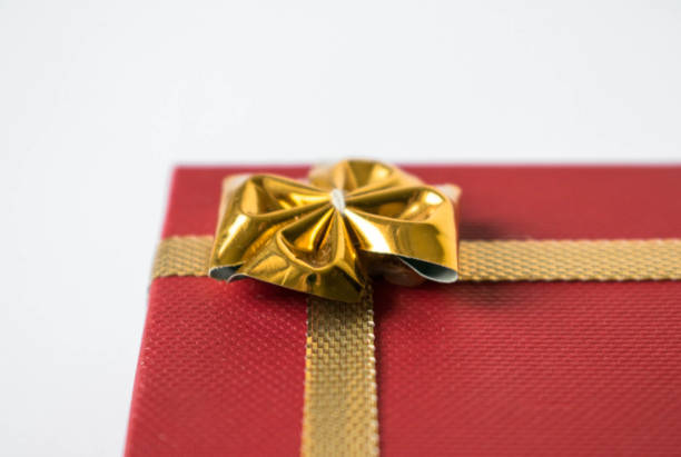 istock Red Gift Box Tied with Shiny Gold Ribbon 1064623052