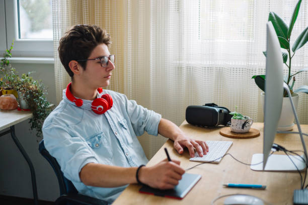 istock Young teenage boy  - graphic designer at work 1064629586